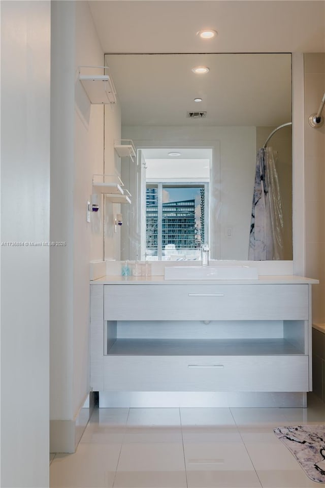 bathroom with tile patterned floors and vanity