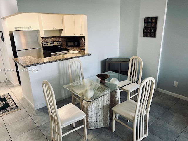 dining space with tile patterned floors