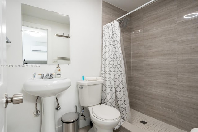 bathroom with sink, a shower with shower curtain, and toilet