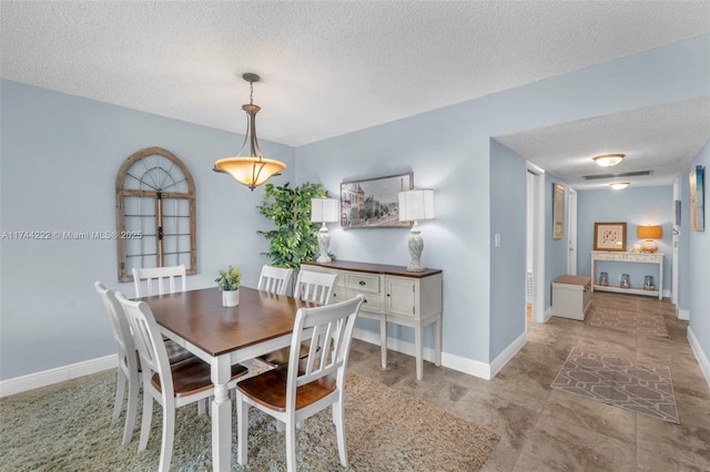 dining room with a textured ceiling