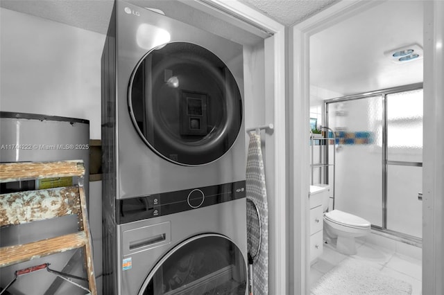 laundry area with a textured ceiling and stacked washing maching and dryer