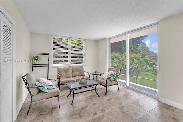 living room with a wall of windows and a textured ceiling