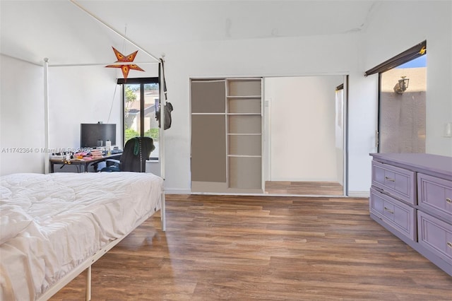 bedroom with dark wood-type flooring