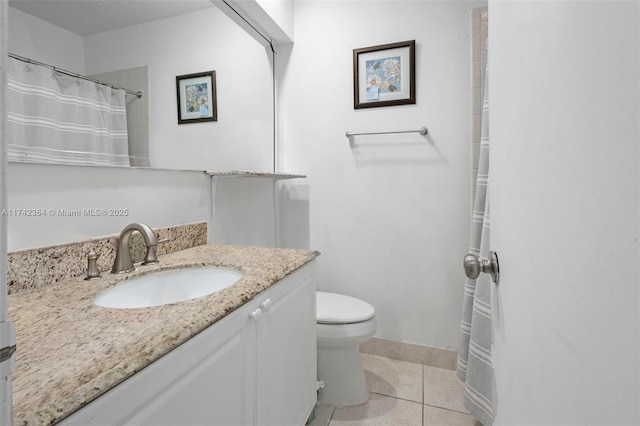 bathroom with tile patterned floors, toilet, and vanity