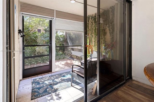 doorway to outside with wood-type flooring