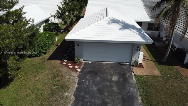 exterior space featuring a garage and a front yard