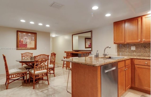 kitchen featuring sink, light stone counters, dishwasher, kitchen peninsula, and backsplash