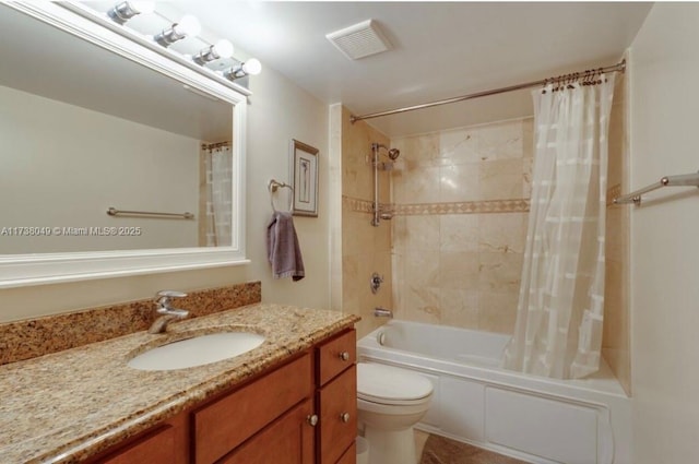 full bathroom with shower / tub combo with curtain, vanity, and toilet