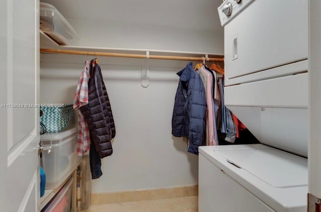 washroom with stacked washing maching and dryer