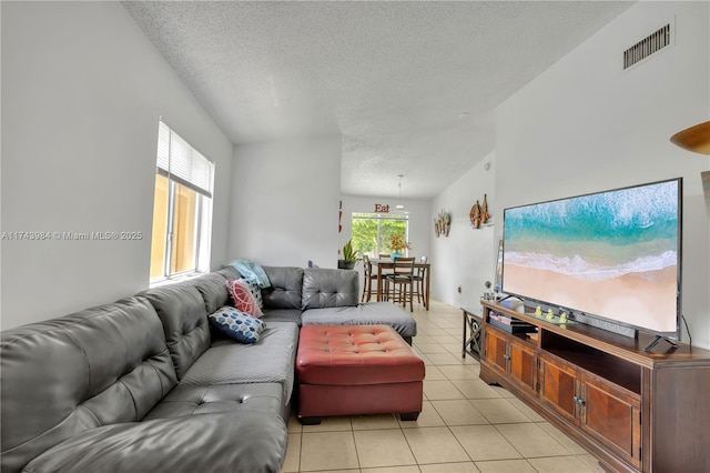 tiled living room with lofted ceiling and a textured ceiling