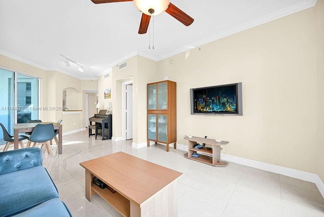 living room with crown molding, light tile patterned floors, track lighting, and ceiling fan