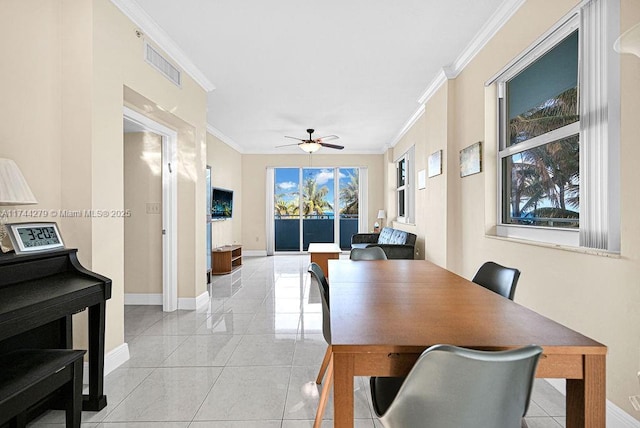 tiled dining space featuring crown molding and ceiling fan