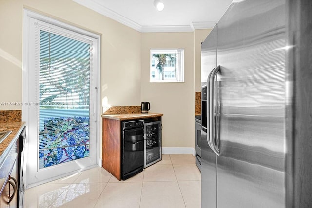 kitchen with ornamental molding, stainless steel fridge, beverage cooler, and light tile patterned floors