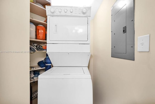 washroom featuring stacked washer and dryer and electric panel