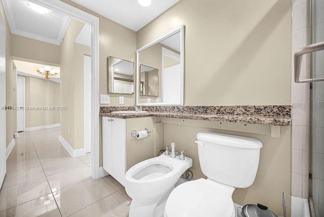 bathroom featuring crown molding, vanity, toilet, a bidet, and tile patterned floors