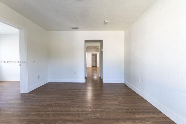 spare room featuring dark hardwood / wood-style floors