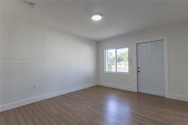 spare room featuring wood-type flooring