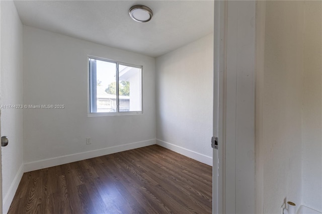 empty room with dark hardwood / wood-style floors
