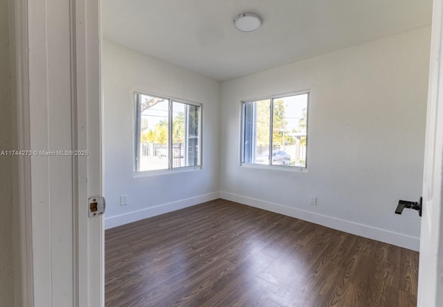 spare room with dark hardwood / wood-style floors