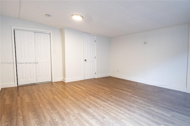 unfurnished bedroom with a closet and light wood-type flooring