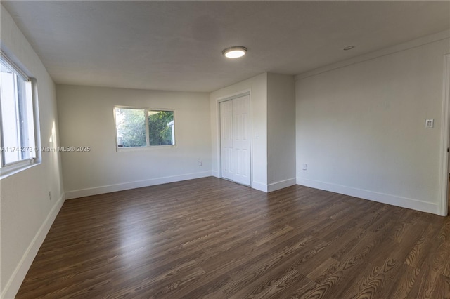 empty room with dark wood-type flooring