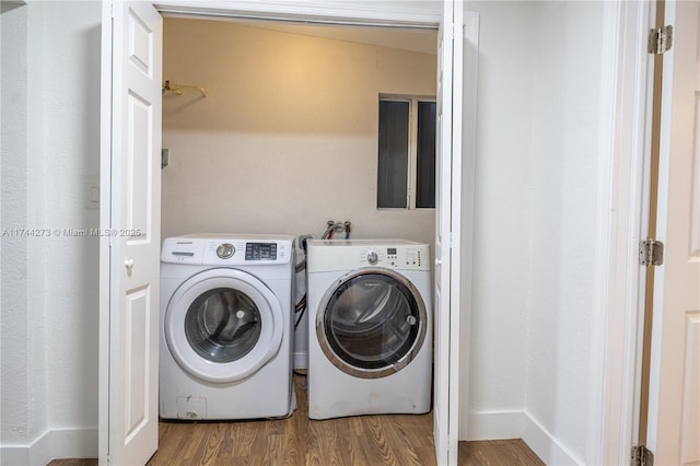 washroom with wood-type flooring and washer and dryer