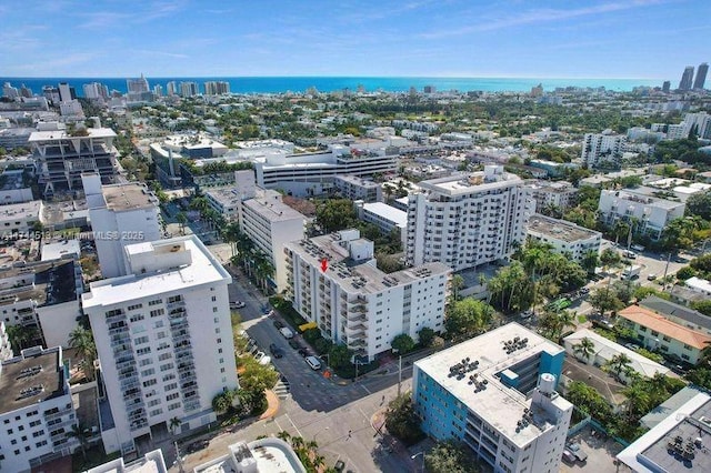 birds eye view of property with a view of city and a water view