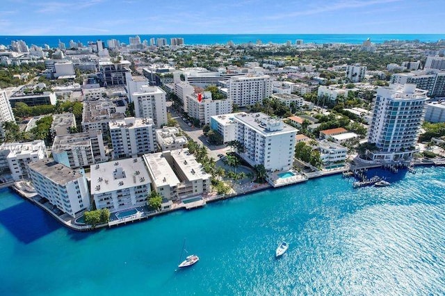 birds eye view of property with a view of city and a water view