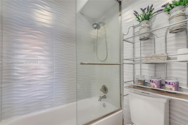 bathroom with shower / bath combination with glass door