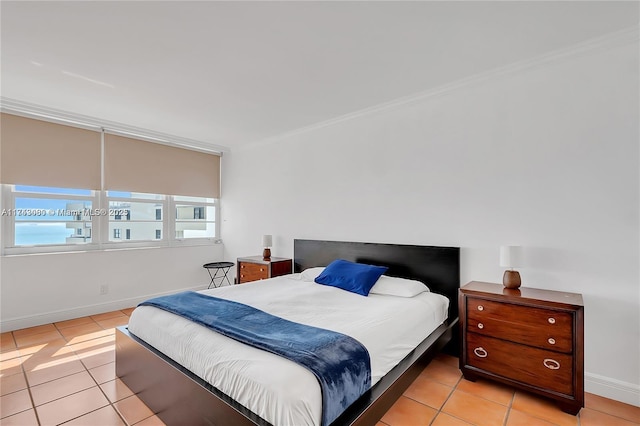 bedroom featuring ornamental molding and light tile patterned flooring