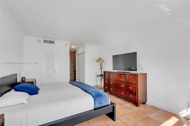 tiled bedroom with ornamental molding and a closet