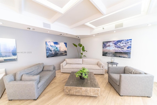 living room featuring coffered ceiling, beam ceiling, and light wood-type flooring