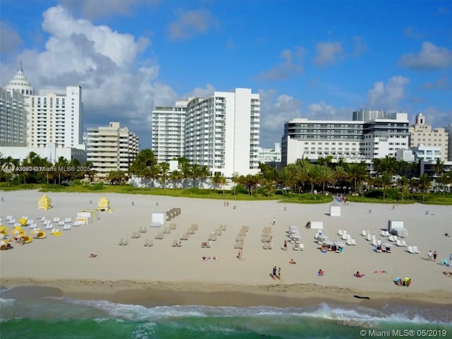 exterior space featuring a water view and a beach view