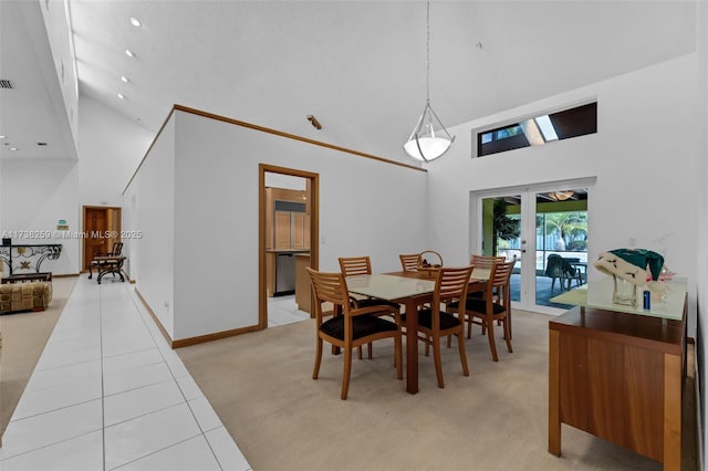 tiled dining area with high vaulted ceiling and french doors