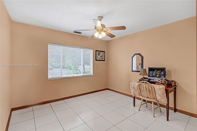 unfurnished office with light tile patterned flooring and ceiling fan