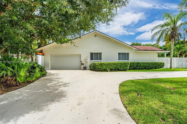 view of front of home with a garage and a front yard