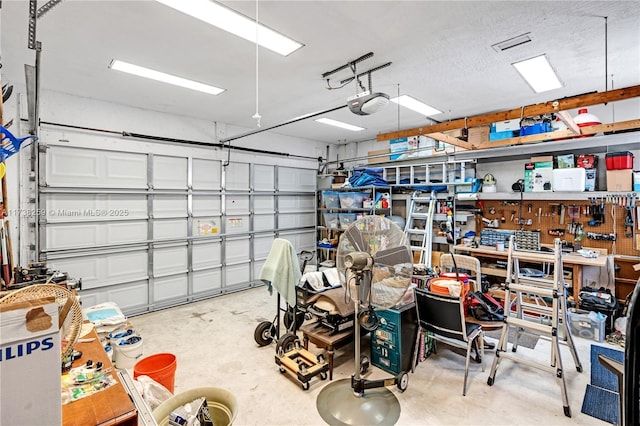 garage with a garage door opener and a workshop area