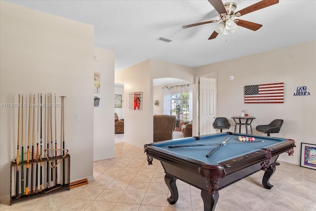 rec room featuring arched walkways, light tile patterned floors, pool table, visible vents, and a ceiling fan