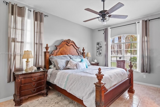 bedroom featuring light tile patterned flooring, ceiling fan, and baseboards