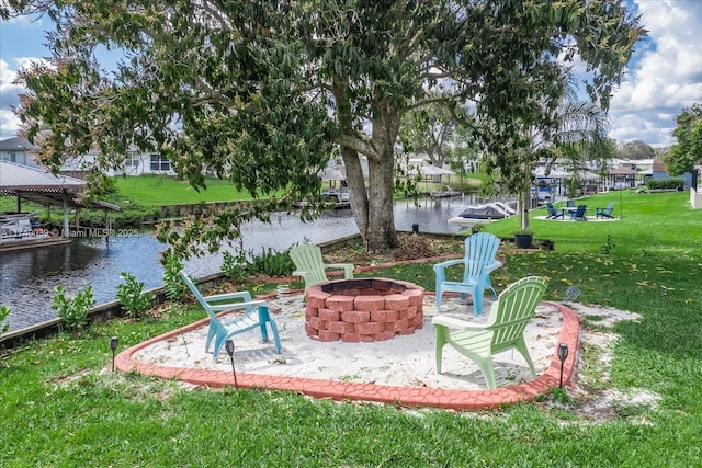 view of yard with a water view and a fire pit