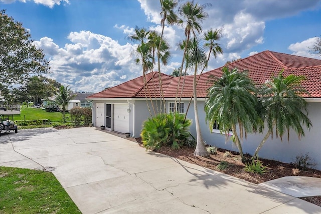 view of front of house featuring a tile roof and stucco siding