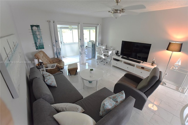 living room featuring a textured ceiling and ceiling fan