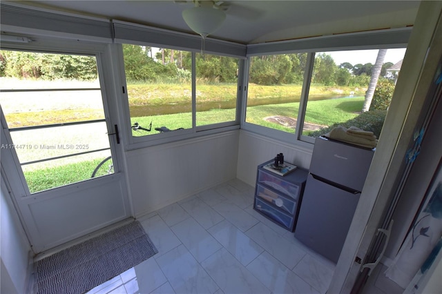 sunroom with ceiling fan and a healthy amount of sunlight