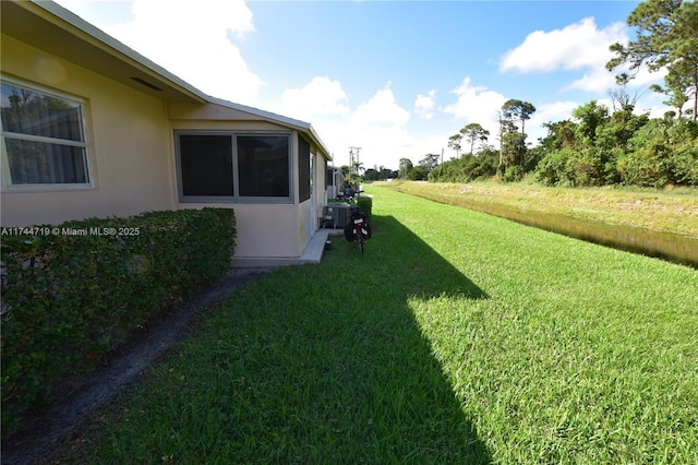 view of yard with central AC