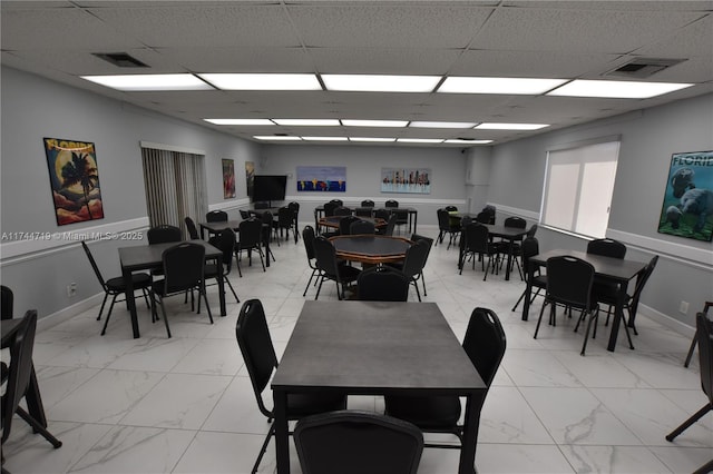 dining room with a drop ceiling