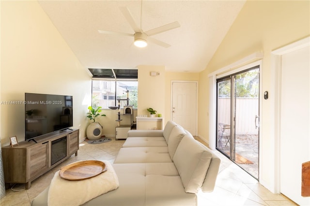 tiled living room featuring lofted ceiling, a wealth of natural light, and ceiling fan