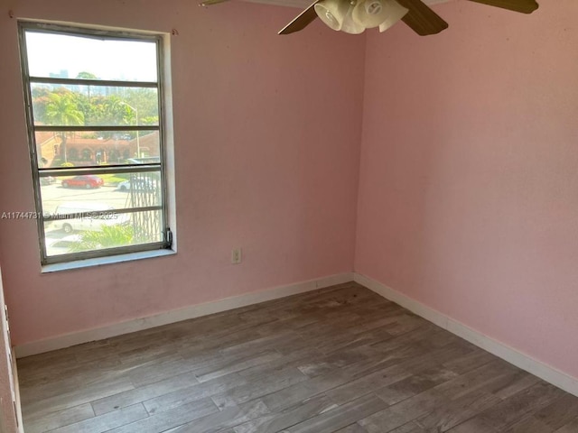 empty room featuring ceiling fan and hardwood / wood-style floors