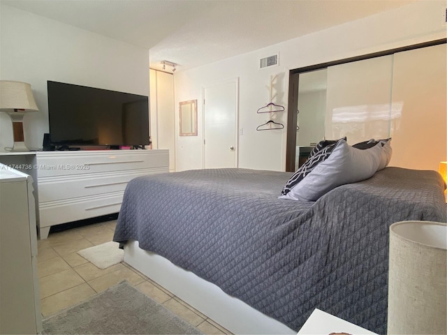 bedroom featuring light tile patterned flooring