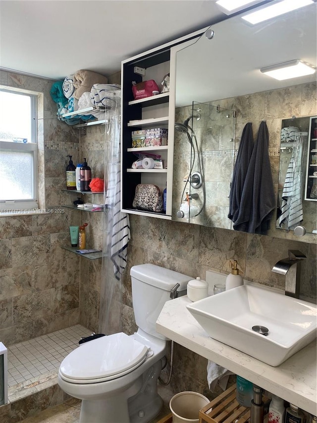 bathroom with sink, tile walls, backsplash, tiled shower, and toilet