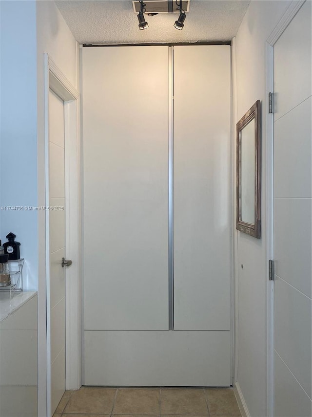 bathroom featuring tile patterned floors and a textured ceiling